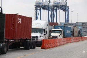 Trucks hauling containers line up for inspection as they depart the Port of Wilmington, NC 